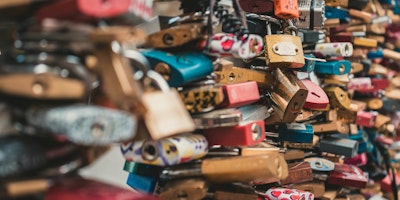 Numerous colorful padlocks attached to a surface