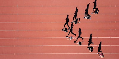Runners on a track, in an arrow formation